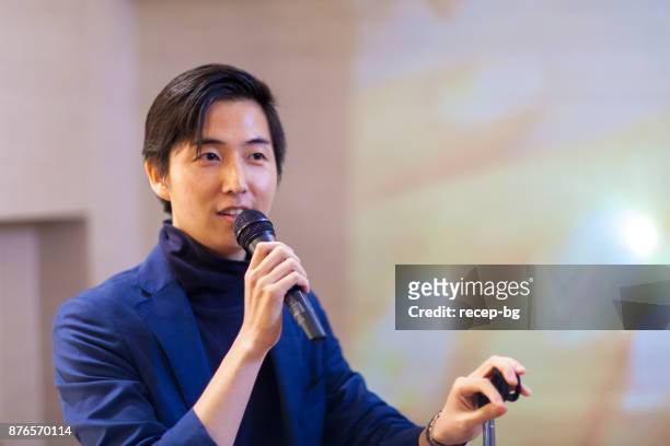 asian businessman giving presentation - press conference stock pictures, royalty-free photos & images