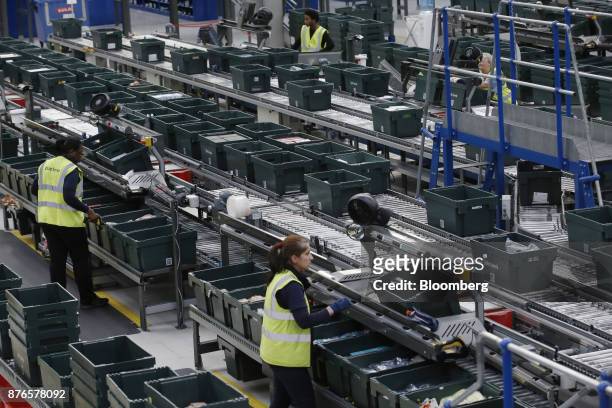Workers pick stock for store replenishment at the John Lewis Plc customer fulfilment and distribution centre in Milton Keynes, U.K., on Friday, Nov....