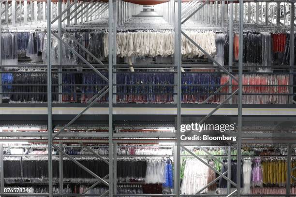 Clothing hangs in the hanging garment automated warehouse at the John Lewis Plc customer fulfilment and distribution centre in Milton Keynes, U.K.,...