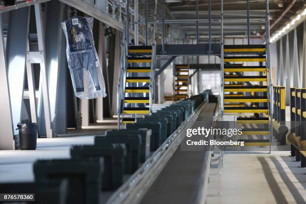 Tote boxes of goods travel on conveyors through the John Lewis Plc customer fulfilment and distribution centre in Milton Keynes, U.K., on Friday,...