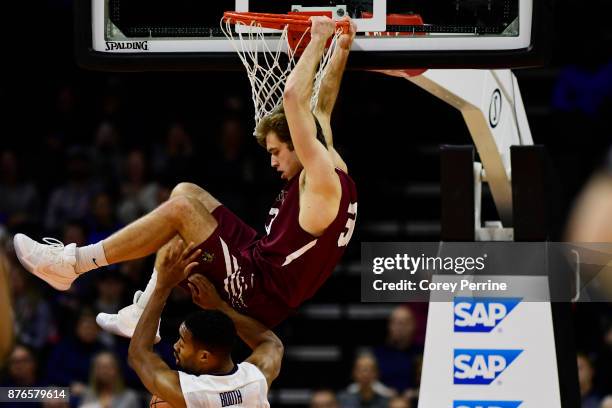 Paulius Zalys of the Lafayette Leopards finishes a fast break with a dunk on Phil Booth of the Villanova Wildcats during the first half at the PPL...