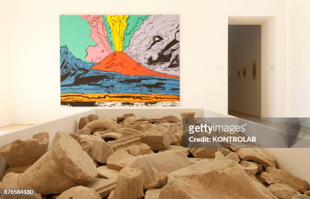 Fragments of marble decorations are displayed next to the work "Vesuvius" by Andy Warhol in the exibition Pompei@madre in the Madre Museum of...