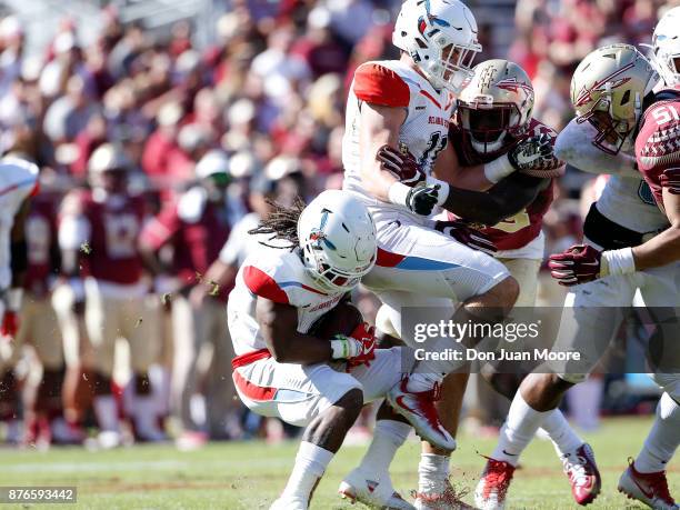 Running back Brycen Alleyne of the Delaware State Hornets collides with teammate Defensive Back Brock Nichols on a kick-off return during the game...