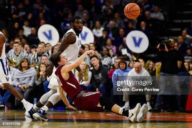 Justin Jaworski of the Lafayette Leopards loses his footing but passes the ball as Eric Paschall of the Villanova Wildcats looks on during the first...