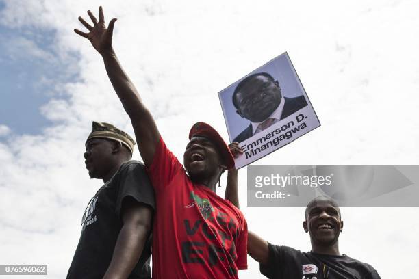 University of Zimbabwe's students, holding a portrait of former vice president Emmerson Mnangagwa, take part in a demonstration on November 20, 2017...