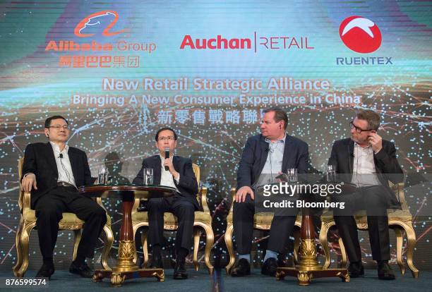 From left to right, Peter Huang, vice chairman of Ruentex Industries Ltd., Daniel Zhang, chief executive officer of Alibaba Group Holding Ltd.,...
