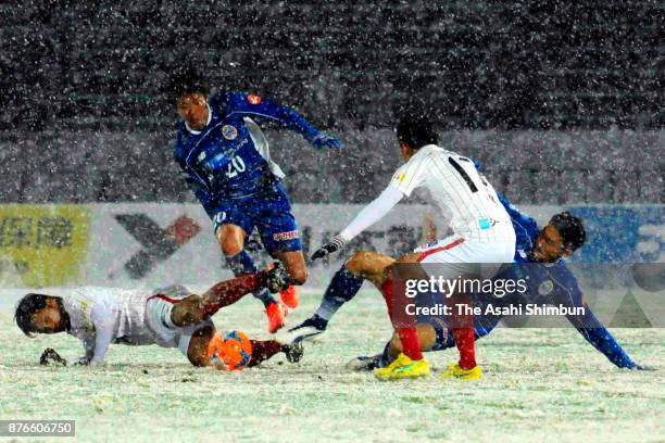 Players compete in the snow during the J.League J2 match between Montedio Yamagata and FC Gifu at ND Soft Stadium Yamagata on November 19, 2017 in...