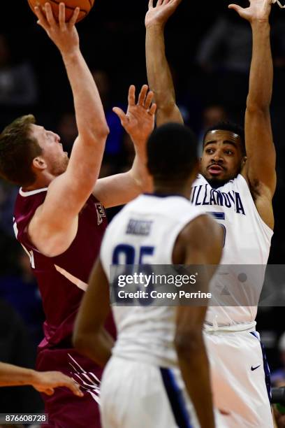 Phil Booth of the Villanova Wildcats defends against Matt Klinewski of the Lafayette Leopards during the first half at the PPL Center on November 17,...