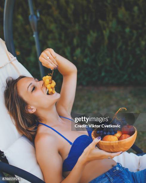 cute girl eat fruit on summer holiday - peach tranquility stock pictures, royalty-free photos & images