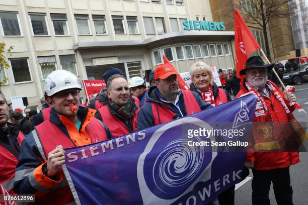 Siemens workers from a nearby dynamo factory gather outside the company's gas turbine factory in Moabit district to protest pending layoffs on...