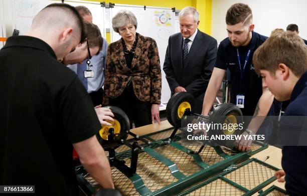 Britain's Prime Minister Theresa May visits an engineering training facility in the Birmingham, central England, on November 20, 2017. British...