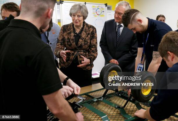 Britain's Prime Minister Theresa May visits an engineering training facility in the Birmingham, central England, on November 20, 2017. British...