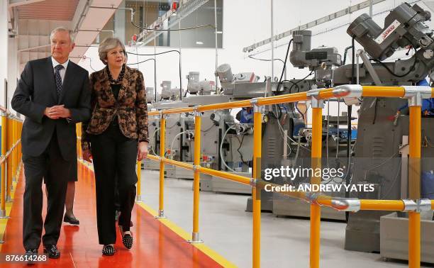 Britain's Prime Minister Theresa May visits an engineering training facility in the Birmingham, central England, on November 20, 2017. British...