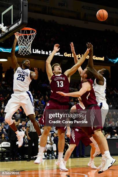 Mikal Bridges of the Villanova Wildcats and Paulius Zalys of the Lafayette Leopards watch as the ball bounces off fingertips during the second half...