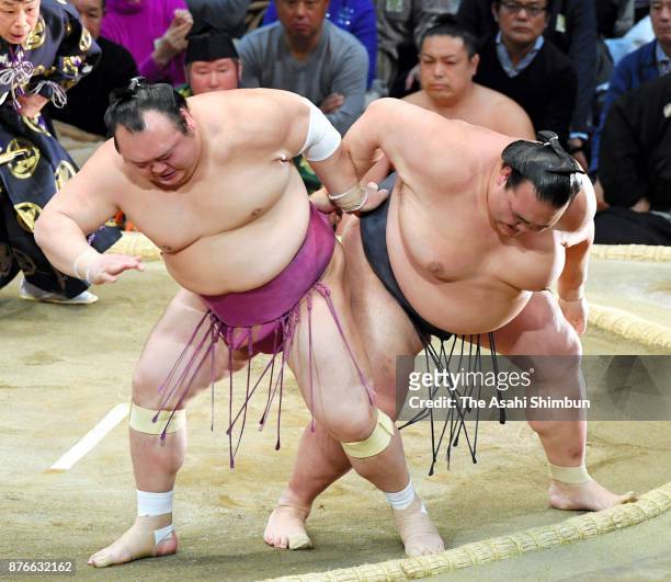 Takarafuji throws yokozuna Kisenosato to win during day nine of the Grand Sumo Kyushu Tournament at Fukuoka Convention Center on November 20, 2017 in...