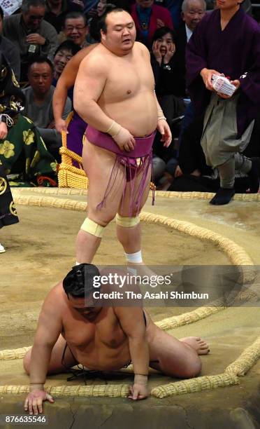 Takarafuji throws yokozuna Kisenosato to win during day nine of the Grand Sumo Kyushu Tournament at Fukuoka Convention Center on November 20, 2017 in...