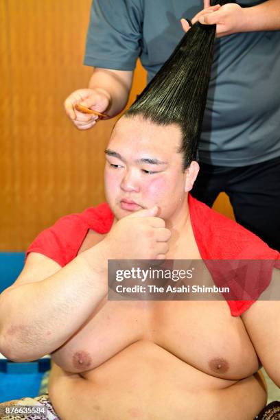 Yokozuna Kisenosato speaks to media reporters while making his topknot done after his defeat by Takarafuji during day nine of the Grand Sumo Kyushu...