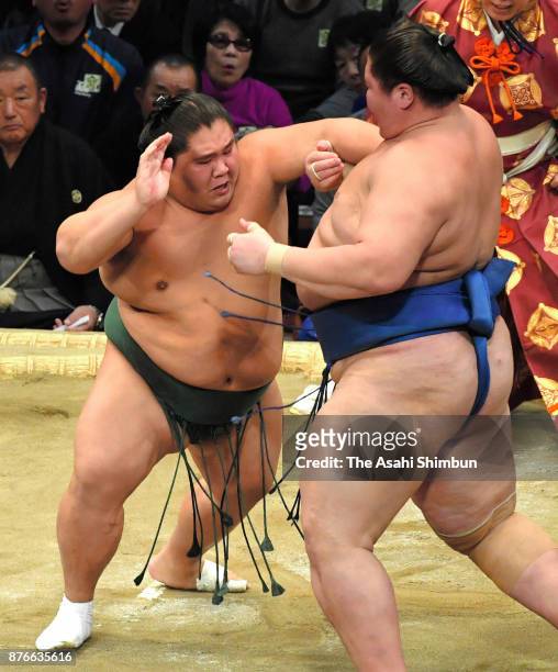 Daishomaru pushes Mongolian wrestler Ichinojo out of the ring to win during day nine of the Grand Sumo Kyushu Tournament at Fukuoka Convention Center...