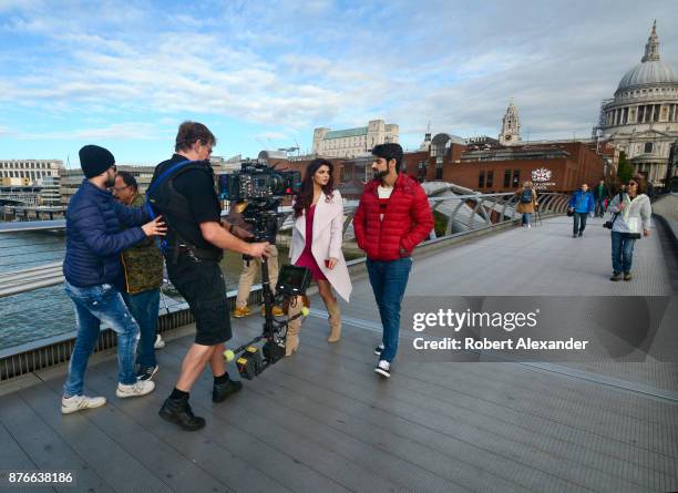 Videographer Mike Scott shoots a scene for the fourth installment of the Bollywood 'Hate Story' film series on Millennium Bridge in London, England....