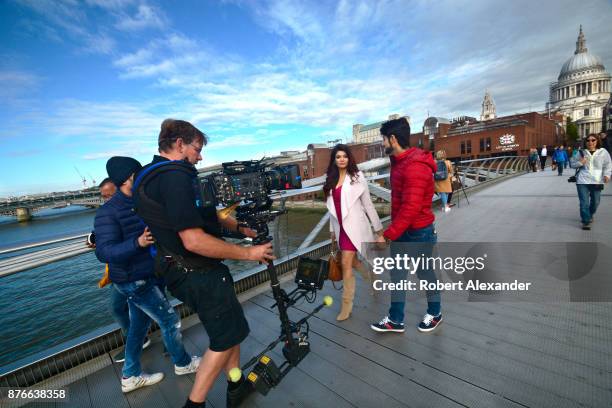 Videographer Mike Scott shoots a scene for the fourth installment of the Bollywood 'Hate Story' film series on Millennium Bridge in London, England....