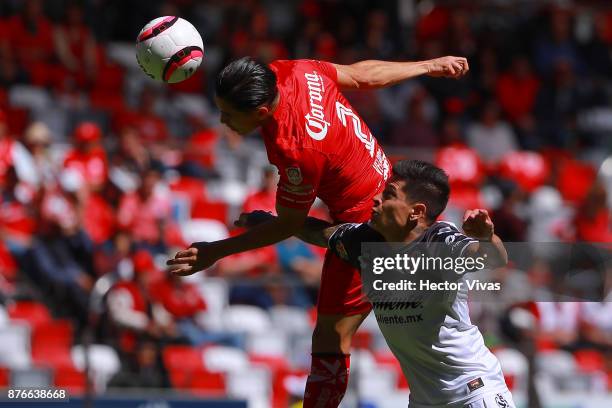 Efrain Velarde of Toluca struggles for the ball with Juan Iturbe of Tijuana during the 17th round match between Toluca and Tijuana as part of the...