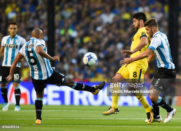 Pablo Perez of Boca Juniors fights for the ball with Arevalo Rios and Miguel Barbieri of Racing Club during a match between Boca Juniors and Racing...
