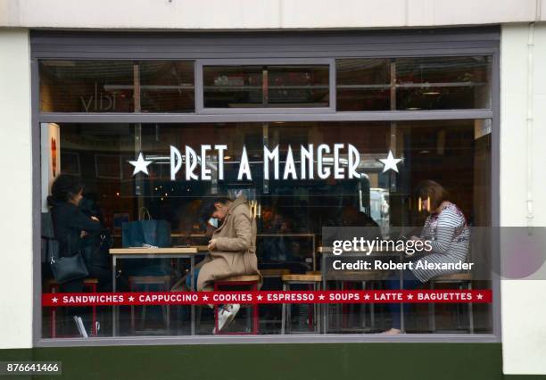 Customers dine at a Pret a Manger natural food restaurant in London, England. Commonly referred to simply as 'Pret', Pret a Manger is an...