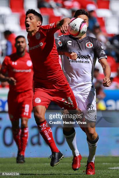 Pablo Barrientos of Toluca struggles for the ball with Damian Musto of Tijuana during the 17th round match between Toluca and Tijuana as part of the...