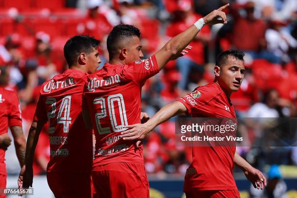 Fernando Uribe of Toluca celebrates with teammates after scoring the first goal of his team during the 17th round match between Toluca and Tijuana as...