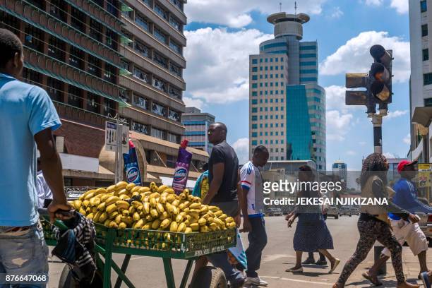 Pedestrians walk by main streets in the Harare's Central Business District on November 20, 2017. Zimbabwe is locked in one of its worst political...