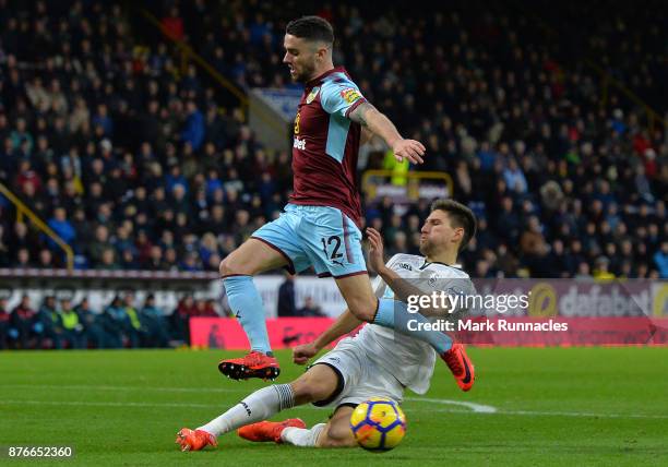 Robbie Brady of Burnley is tackled by Federico Fernandez of Swansea City during the Premier League match between Burnley and Swansea City at Turf...