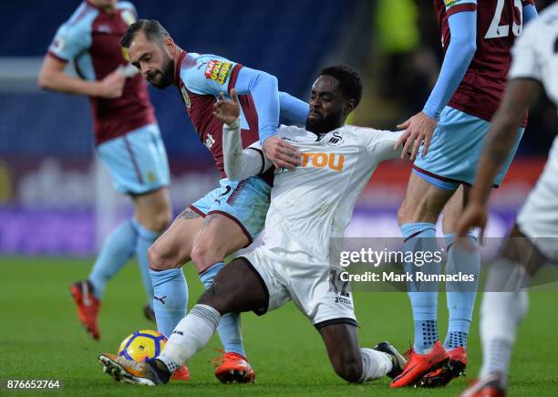 Steven Defour of Burnley is tackled by Nathan Dyer of Swansea City during the Premier League match between Burnley and Swansea City at Turf Moor on...