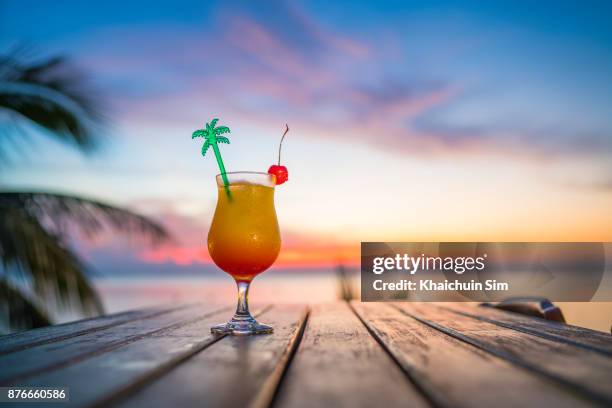 cocktail during sunset at beach - summer sunset stock pictures, royalty-free photos & images