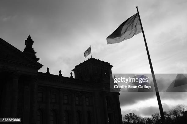 German flags fly at the Reichstag, seat of the German parliament, the Bundestag, on November 20, 2017 in Berlin, Germany.Preliminary coalition talks,...