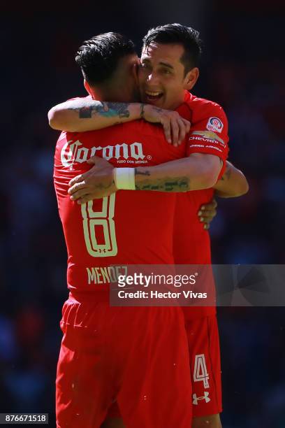 Jesus Mendez of Toluca celebrates with teammate Rubens Sambueza after scoring the third goal of his team during the 17th round match between Toluca...