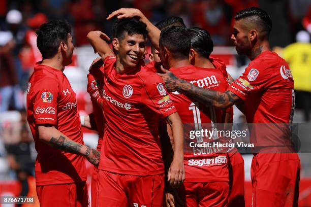 Fernando Uribe of Toluca celebrates with teammates after scoring the second goal of his team during the 17th round match between Toluca and Tijuana...