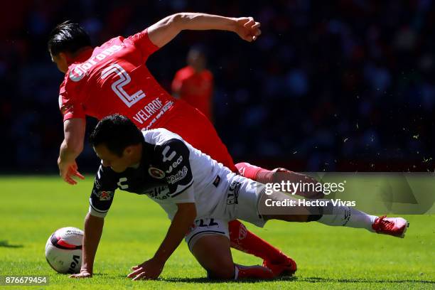 Juan Nuñez of Tijuana struggles for the ball with Efrain Velarde of Toluca during the 17th round match between Toluca and Tijuana as part of the...