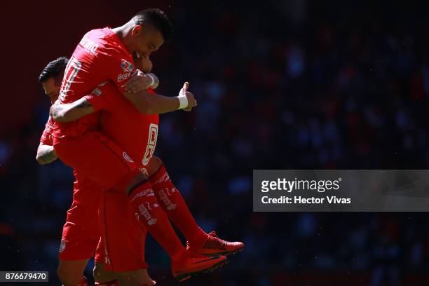 Jesus Mendez of Toluca celebrates with teammates after scoring the third goal of his team during the 17th round match between Toluca and Tijuana as...
