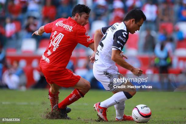 Rubens Sambueza of Toluca struggles for the ball with Juan Nuñez of Tijuana during the 17th round match between Toluca and Tijuana as part of the...