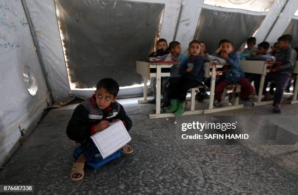 Displaced Iraqi children from the former embattled city of Mosul attend class at a United Nations Children's Fund school at the Hasan Sham camp, some...