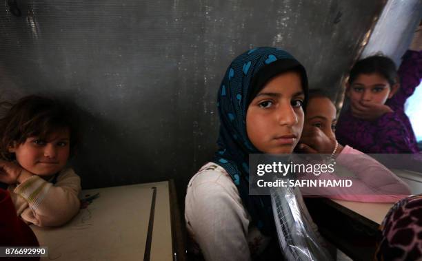 Displaced Iraqi children from the former embattled city of Mosul attend class at a United Nations Children's Fund school at the Hasan Sham camp, some...