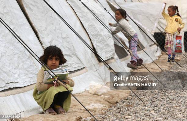 Displaced Iraqi children from the former embattled city of Mosul are seen at a United Nations Children's Fund school at the Hasan Sham camp, some 40...