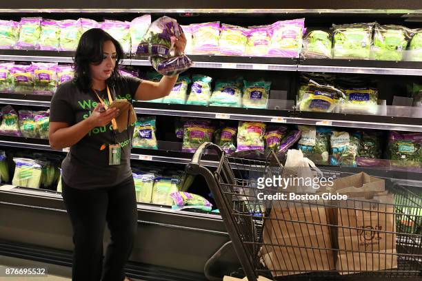 In-store shopper Rita Dominique fills a customer's order in the produce section at Wegmans in Newton, MA on Nov. 15, 2017. Thanksgiving serves as...