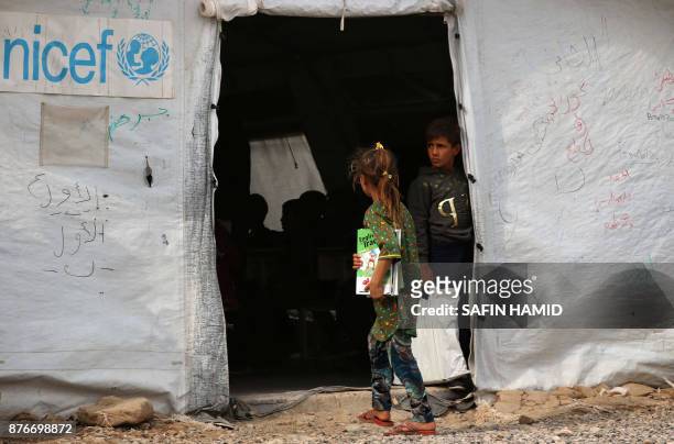 Displaced Iraqi girl walks into a United Nations Children's Fund school at the Hasan Sham camp, some 40 kilometres east of Arbil in northern Iraq, on...