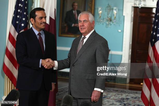 Secretary of State Rex Tillerson participates in a photo opportunity as he shakes hands with Qatari Foreign Minister Sheikh Mohammed bin Abdulrahman...