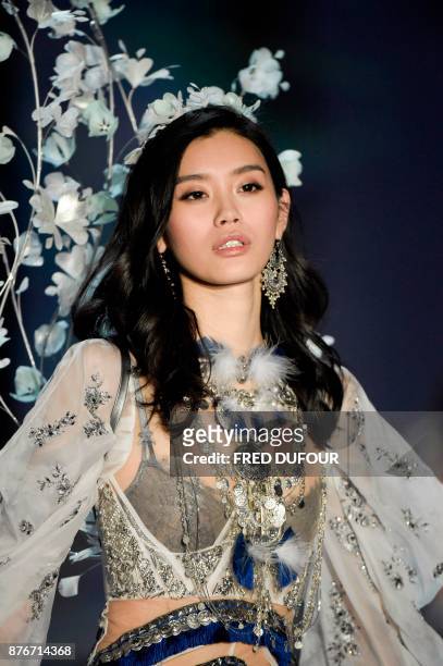 Chinese model Ming Xi presents a creation during the 2017 Victoria's Secret Fashion Show in Shanghai on November 20, 2017. / AFP PHOTO / FRED DUFOUR...