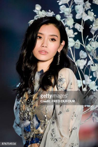 Chinese model Ming Xi presents a creation during the 2017 Victoria's Secret Fashion Show in Shanghai on November 20, 2017. / AFP PHOTO / FRED DUFOUR...