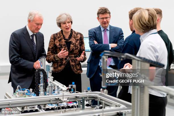 Britain's Prime Minister Theresa May and Britain's Business, Energy and Industrial Strategy Secretary Greg Clark visit an engineering training...