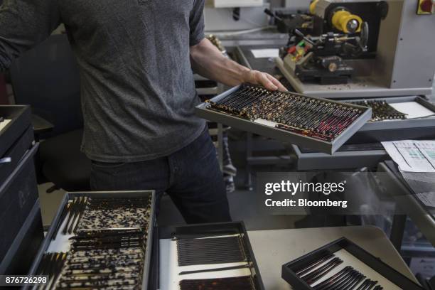 Worker moves trays of eyeglass frame temples at the Lowercase manufacturing facility inside the Brooklyn Army Terminal in the Brooklyn Borough of New...