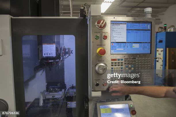 Worker operates a machine cutting material for eyeglasses at the Lowercase manufacturing facility inside the Brooklyn Army Terminal in the Brooklyn...